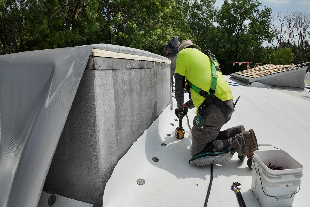 Windward Roofing technician performing commercial roof maintenance inspection