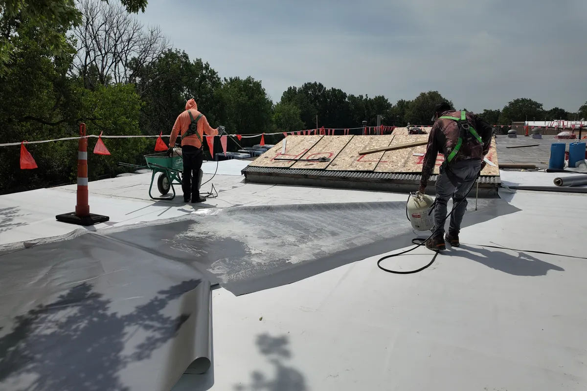 Windward Roofing workers installing a commercial roof replacement system