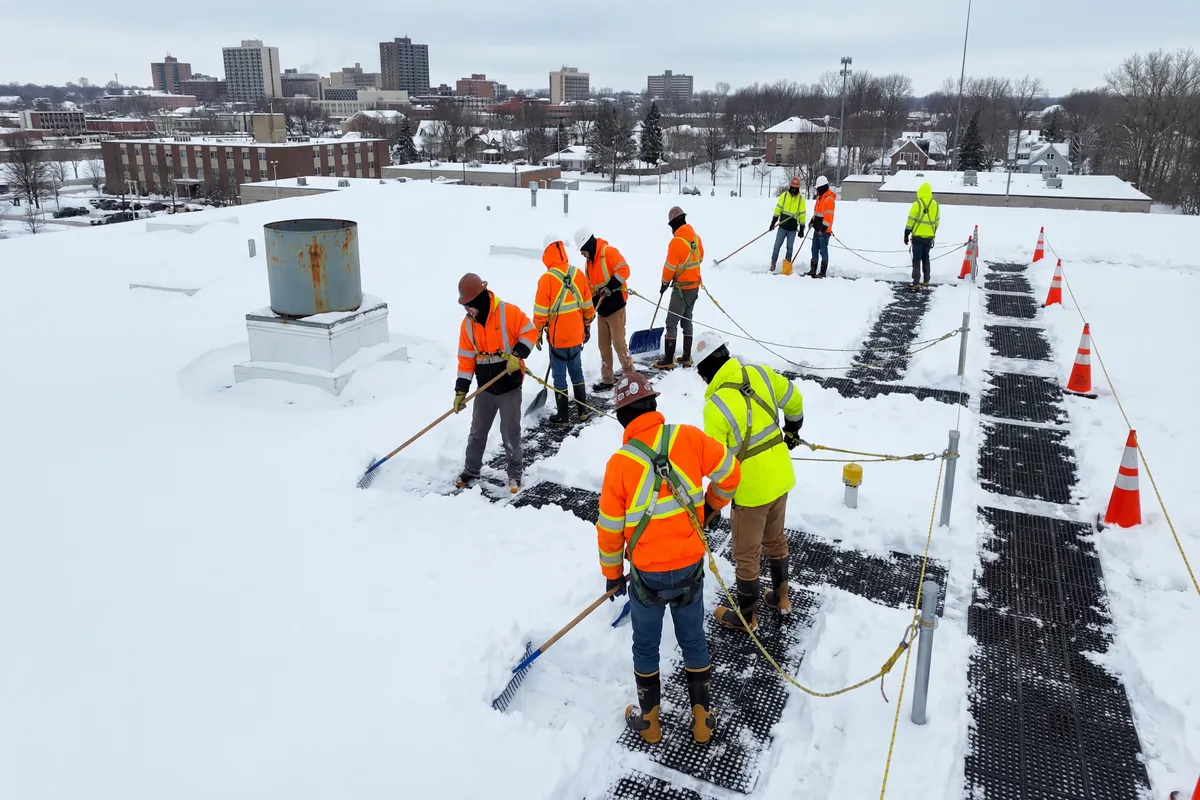 Windward Roofing crew performing commercial roof snow removal in Chicago